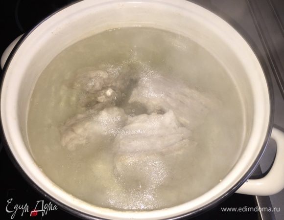 Я варю гороховый суп всегда на свинине. Причем на свиных ребрах. Выбирайте некрупные, максимально постные, симпатичные куски с костями. Если есть лишний жир, безжалостно срезайте.
Горох можно замочить на ночь, но я часто забываю это делать, и современный колотый горох в целом в этом не нуждается. Можно просто замочить его, как только вы собрались варить суп, еще до разделки мяса и т.п. Пока дойдет до его закладки, он как раз чуть-чуть разбухнет.
Итак: моем мясо, кладем в кастрюлю, заливаем водой и ставим на огонь. Снимаем всю пену, убавляем огонь и сразу закидываем горох.
Можно и нужно добавить 8 — 10 горошин душистого перца и лавровый лист. На час оставляем вариться. Через час солим.