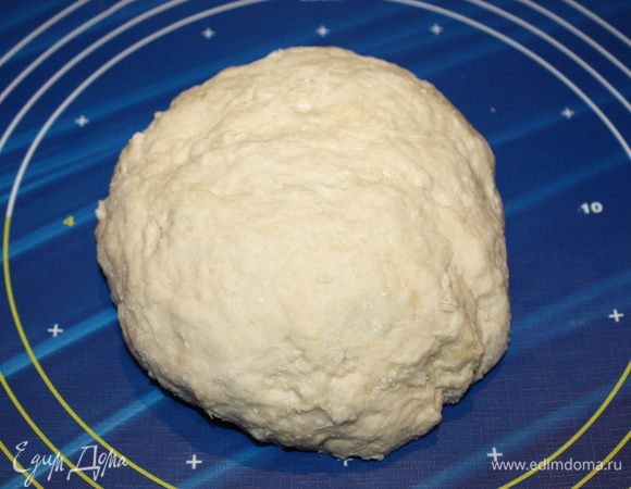 Тесто слегка может приставать к ладоням. Если оно у вас сильно пристает, добавьте немного муки. У меня замесилось тесто в хороший комок, который не пристает к рукам, и я выложила на рабочую поверхность. С виду получилось отличное тесто, но оно еще не готово для прослойки.