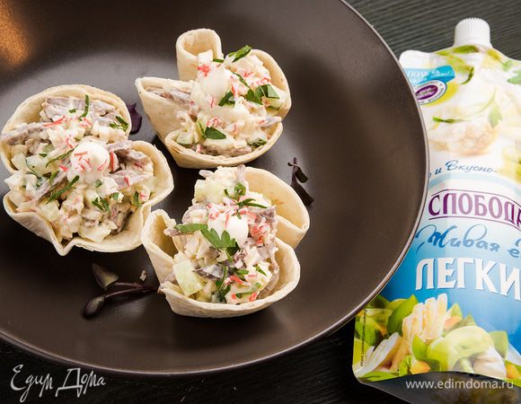 Выложить салат порционно в готовые корзинки.