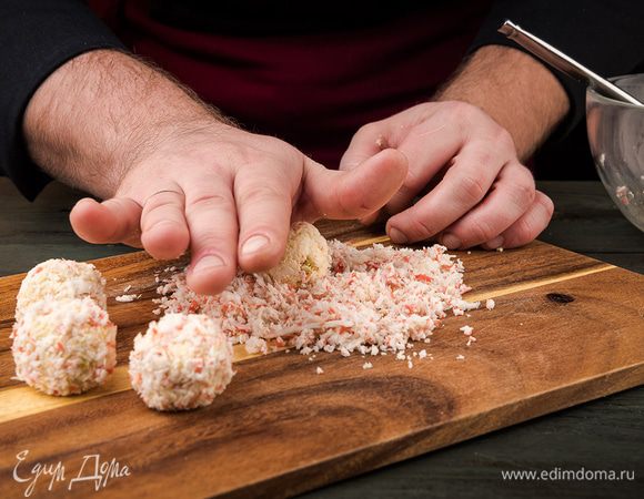 Из сырно-крабовой массы скатать шарики. Обвалять их в крабовой стружке.