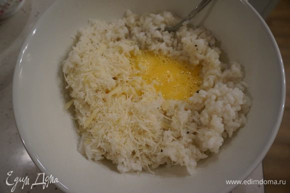 Рис снимаем с огня. Солим по вкусу, добавляем сливочное масло, тертый пармезан и яйцо. Перемешиваем.