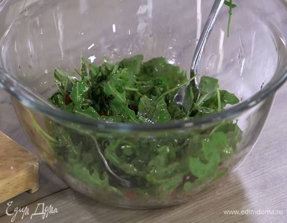 Руколу выложить в глубокую посуду, полить заправкой, добавить зерна граната и перемешать.