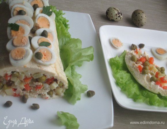 Переворачиваем салат на блюдо, освобождаем от пленки и начинаем украшать: яйцами, зеленью, каперсами.