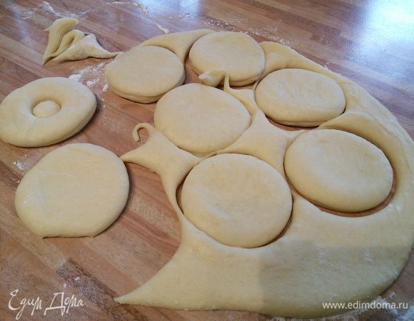 Тесто раскатать на посыпанной мукой поверхности в толстый пласт. Стаканом выдавить кружочки, в центре выдавить середину (я для этого приспособила крышечку из под пузырька с каплями от кашля :)).