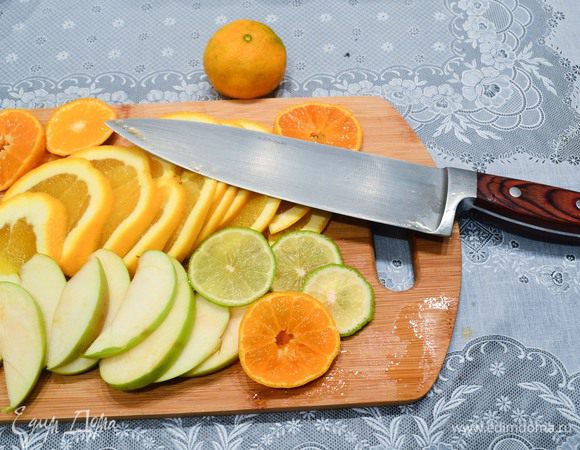 Фрукты нарежем. Я предпочитаю резать тонко, но крупными ломтиками, так фрукты отдают максимум сока, но при этом не норовят попасть в бокал, когда разливаешь глинтвейн. 
Не перестарайтесь с лаймом, его нужно буквально пару прозрачных кружков. Добавите больше получится кисло. Не спасет никакой сахар (проверено на собственном опыте).