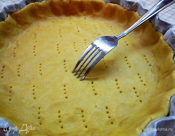 Раскатываем тесто, укладываем в форму, формируя бортик, накалываем тесто вилкой. Выпекаем в разогретой духовке при температуре 180°С 25 — 30 минут. Достаем и даем остыть.