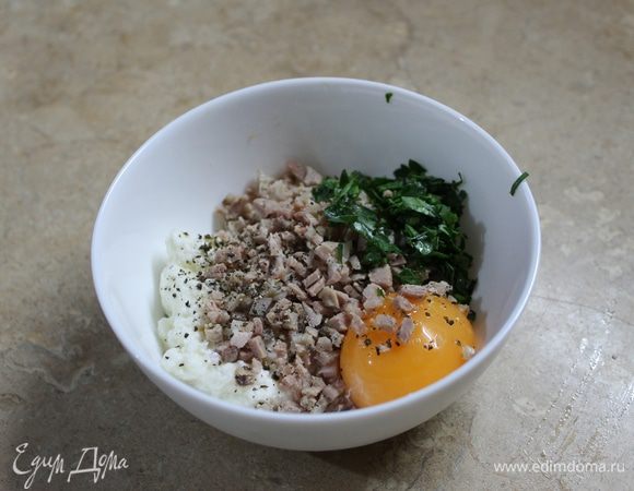 Пока отвариваете фенхель, можно приготовить начинку. Мелко нарежьте ветчину и зелень, измельченную сердцевину фенхеля, все добавьте к рикотте, вбейте желток, соль по вкусу и перец, перемешайте. Начинка готова.