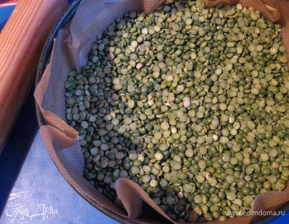 Духовку разогреть до 180°С. Выложить горох (фасоль) на основу для теста, предварительно закрыв ее бумагой для выпечки. Поместить в духовку минут на 15 — 20. Вынуть из духовки, убрать горох и бумагу сверху теста.