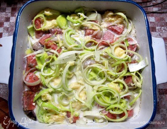 Молочную смесь добавить к рыбе и слегка перемешать. Запекать 25 минут при 180°С, затем вынуть рыбу из духовки, посыпать остатками сыра и допечь еще 5 минут до его расплавления.