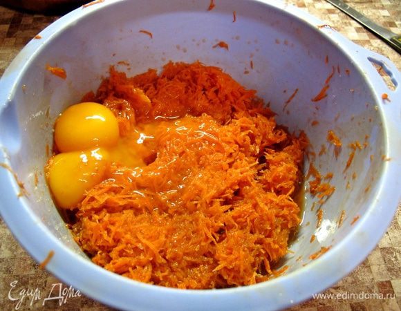 Натрите морковь на мелкой терке. Слейте образовавшийся сок. Если будете украшать печенье тертой морковью, отложите немного в сторону. Яйца хорошо промойте. Разделите на желтки и белки. Желтки добавьте к моркови.