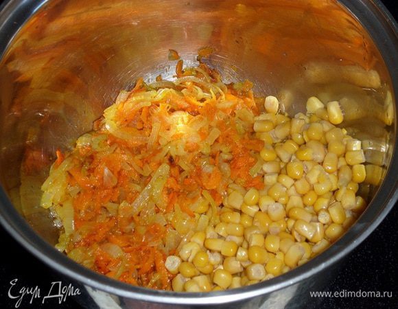 В кастрюлю выкладываем обжаренные овощи и консервированную кукурузу.