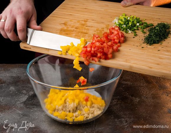 К киноа добавить нарезанные овощи и зелень, посолить, поперчить и перемешать.