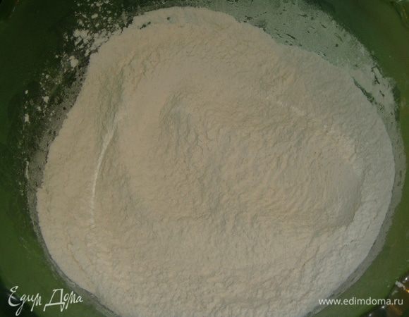 В миску просеять 4 стакана муки, добавить дрожжи и перемешать.