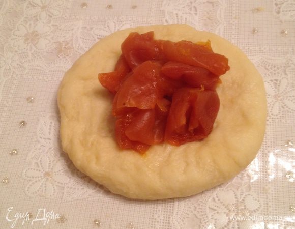 Сформируйте из каждого шарика маленькую лепешку и положите на середину начинку, защипайте края.