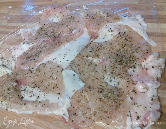 Разложить куриные шкурки со слоем мяса на пленке. Постараться не оставить свободных мест, если необходимо где-то отрезать, а где-то подлатать. 