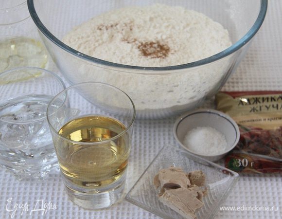 Понадобится: 500 г муки в/с, 140 г воды, 100 г белого вина, 30 г свежих дрожжей, 1 ч.л. соли, 3 ч. л. сахара, 5 ст. л. растительного масла, щепотка сухой аджики.