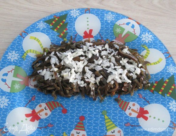 В этом варианте первым слоем будет морская капуста. Если в банке она была в виде длинных водорослей, то лучше их немного укоротить, нашинковать поперек для удобства и раскладки по порциям, и поедания.