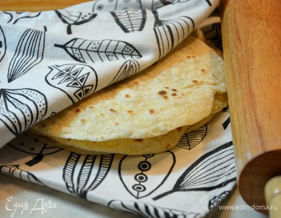 Разделить тесто на 7 — 8 кусков, раскатать лепешки и жарить на хорошо разогретой сковороде без масла. 
Готовим гарнир. Рис хорошо промыть. Рис варю всегда в соотношении 1:1,5 (рис:жидкость). Имейте в виду, при промывании риса крупа впитывает часть воды, поэтому добавлять нужно немного меньше воды, чем указано в рецепте. У меня 300 г риса впитало 35 мл воды, поэтому я добавила 415 мл бульона вместо 450 мл. Добавить в кастрюлю с толстым дном рис и куриный бульон. Варить 12 минут после закипания на сильном огне. Выключить, снять с плиты и оставить еще на 12 минут. Если бульон был несоленый — посолить. Рис готов.