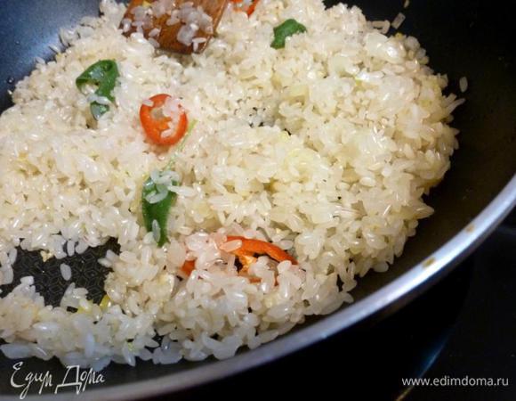 Всыпаем рис и жарим на масле пока рисинки не побелеют. Помешивайте все время.
