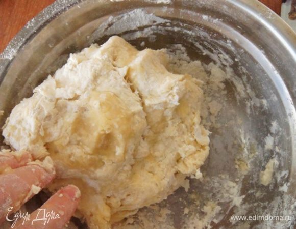 Постепенно вливая очень холодную воду, замесить тесто. Добавить оливковое масло и продолжить месить руками. 