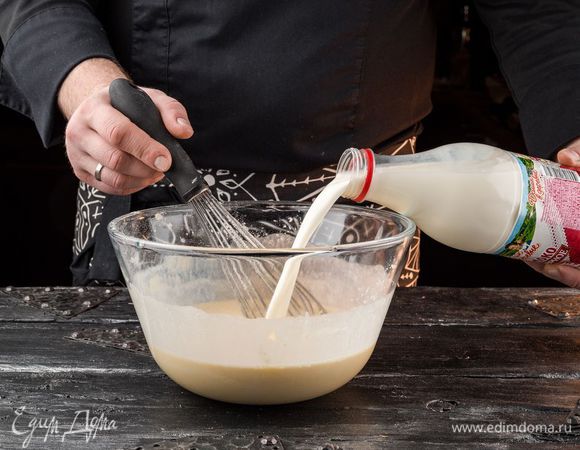 Добавляем муку, перемешиваем и постепенно добавляем молоко «Домик в деревне», не переставая мешать. В конце добавляем растительное масло и хорошенько размешиваем.