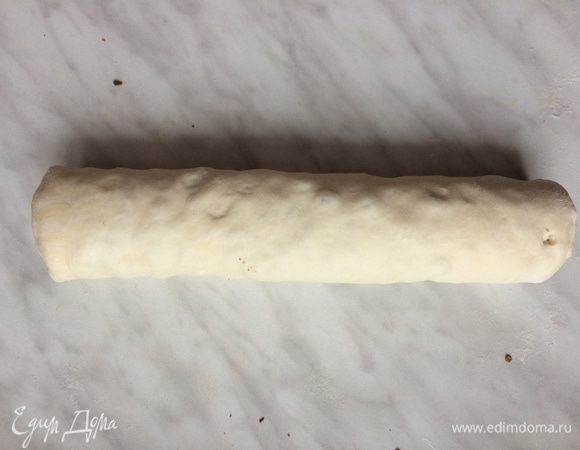 Сверните тесто в тугой рулет и нарежьте поперек толщиной 5 см и выложите в форму.