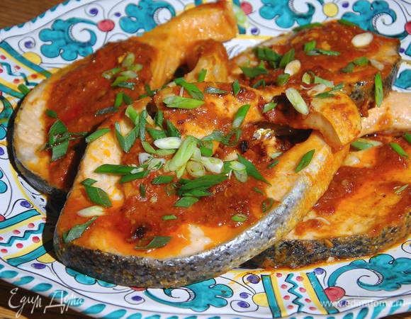 Рыбу с соусом выложить на блюдо и посыпать зеленым луком.