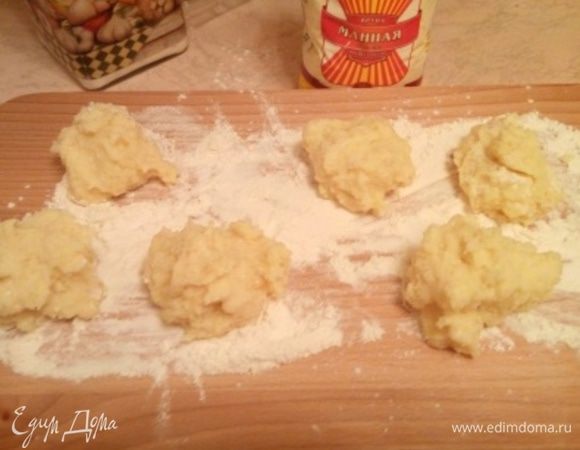 На рабочую поверхность насыпаем муку, муки должно быть достаточное количество, и ложкой выкладываем манную кашу кучками из указанного количества получатся 6 — 8 зраз. Если наши манные кучки хорошо держат форму, значит мы на пути к успешному результату. Манка хорошая, и заварили мы ее правильно. Теперь формируем лепешечки толщиной 8 — 10 мм каждая, просто легонько прихлопывая.