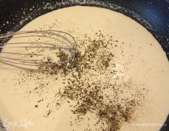 Добавить муку, перемешать. Затем начать постепенно добавлять воду и сливки, постоянно помешивая, чтобы не образовались комочки. Затем добавить специи, соль, черный перец и перемешать.