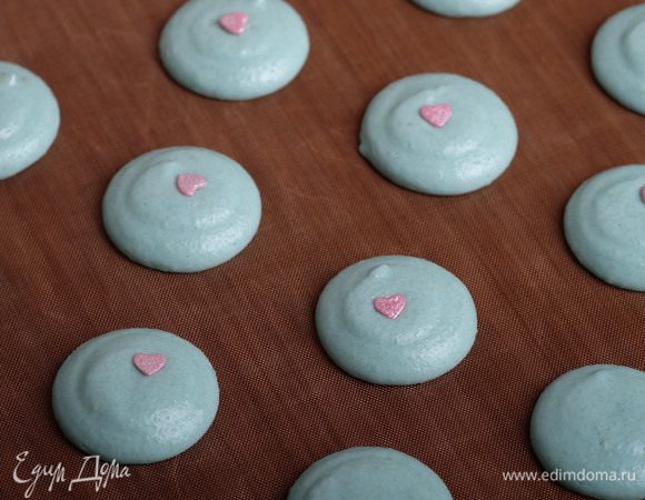 Перекладываем готовый макаронаж в подготовленный заранее кондитерский мешок и начинаем отсаживать быстрыми движениями макарон. Я готовила макарон ко Дню влюбленных, поэтому сверху посыпала сахарной посыпкой в виде сердечек, также на этом этапе макарон можно посыпать пудрой, орехами и т.д.