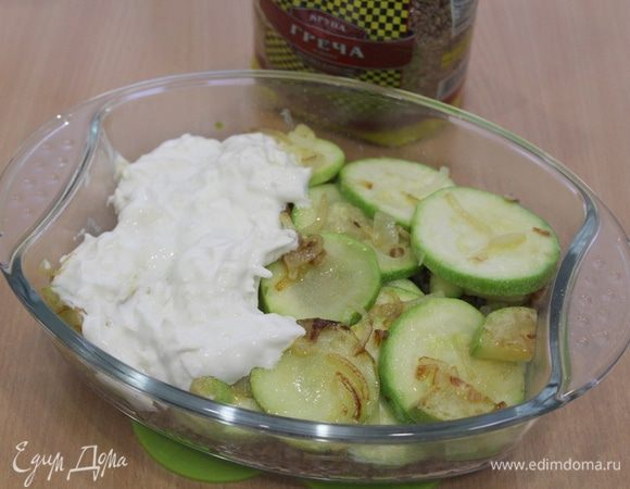 Смешайте сыр, сметану и воду. Вылейте в гречку и перемешайте. Выложите сверху половину обжаренных кабачков, и опять сырная масса (можно сделать два слоя).