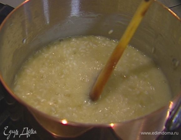 Небольшими частями вливать в рис горячий бульон и готовить 15–18 минут — рис должен стать мягким, но при этом не превратиться в кашу.