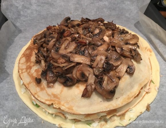 Затем положите половину грибной начинки и тоже накройте блином.