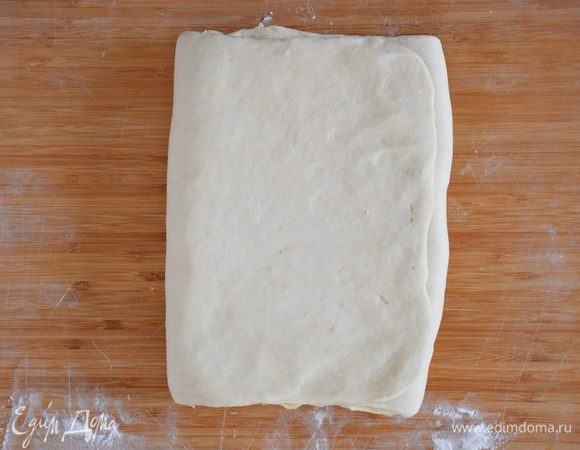 Положить масло на одну половинку теста, закрыть другой. Подровнять тесто с маслом.