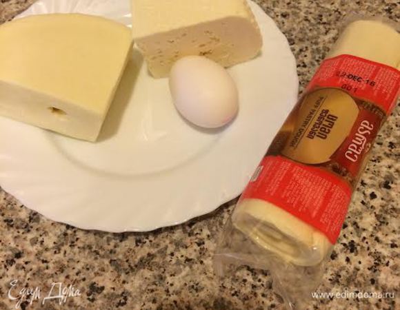 Духовку нагреть до 190°С. Готовое слоеное тесто достать из холодильника и дать полежать 15-20 минут. Сыр натереть на крупной терке.