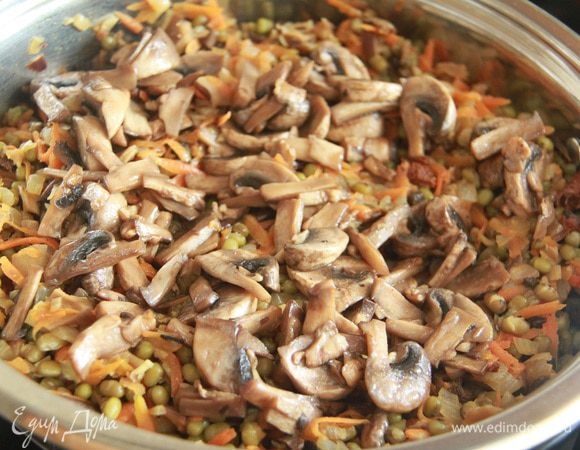 Добавить шампиньоны к общему блюду и потомить на огне еще 10 минут.