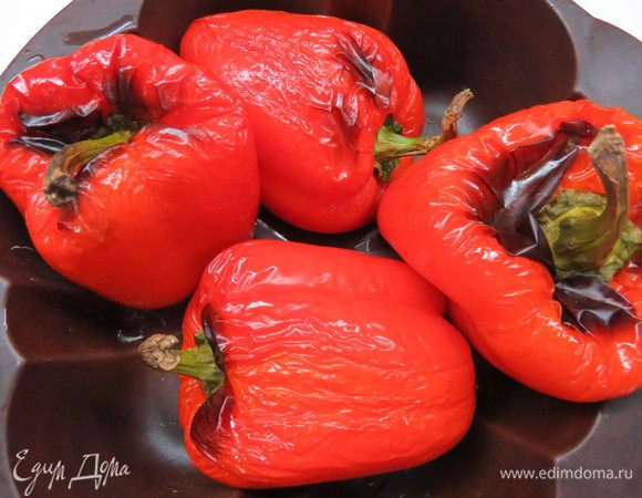 Сначала подготовим перец. Красный перец помыть, вытереть насухо и смазать оливковым маслом. Запекать в духовке при 180°С 35-40 минут до черных подпалин. Затем перец достать и накрыть крышкой, оставить минут на 10.