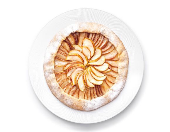 Тесто раскатайте на присыпанной мукой поверхности в круг толщиной 4 мм. В центр круга выложите ломтики яблок и груш внахлест, отступив от края 2–3 см. Затем аккуратно подверните края на начинку. Присыпьте фрукты тростниковым сахаром. Выпекайте пирог при температуре 190°С в течение 40–45 минут. Украсьте пирог веточкой мяты и подавайте с мороженым.
