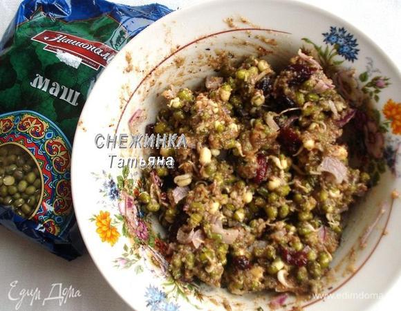 В миске соединяем маш, вяленую клюкву и лук, смешиваем с заправкой.