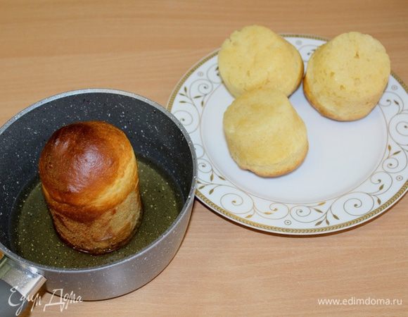 Для сиропа смешать воду и сахар, кипятить 5 минут, затем немного остудить и добавить ром. Достать ром-бабы из формы окунуть в сироп.