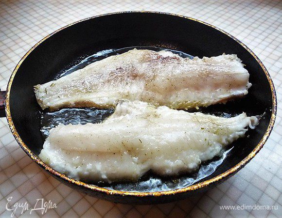 В сковороду с маслом выкладываем окуня кожей вниз и жарим 2 минуты.