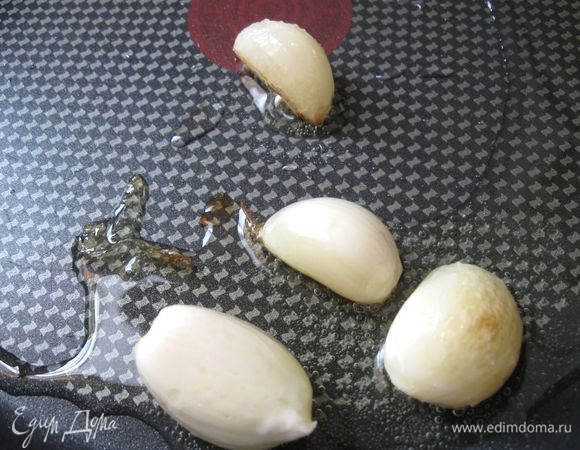 В разогретое на большой сковороде оливковое масло положить зубчики чеснока, прогреть немного, чтобы чеснок отдал свой аромат, вынуть чеснок.