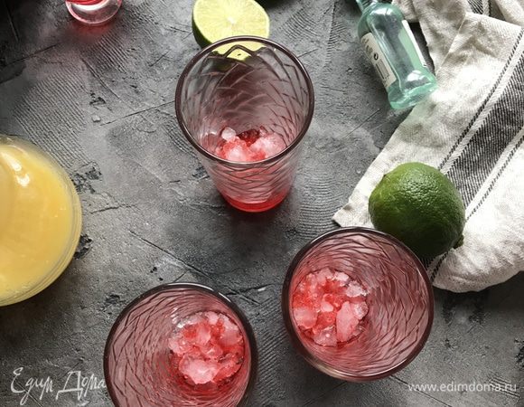 Сверху полейте клубничным сиропом, затем выложите слой льда. Влейте в каждый стакан по 50 мл Bacardi, апельсиновый сок, лед и немного сока лайма.  