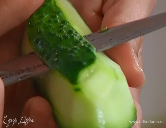Огурец очистить от кожицы и нарезать тонкими ломтиками.