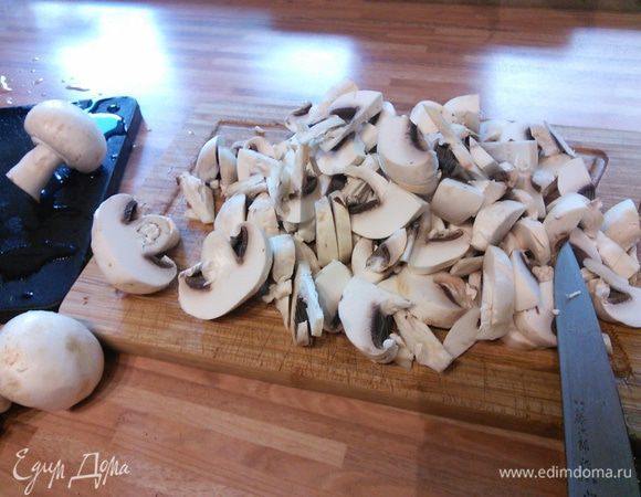 Разогреть оба вида масла, спассеровать мелко рубленый лук. Грибы очистить и произвольно порезать.