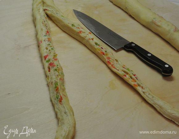 Острым ножом разрезать рулет вдоль на 2 части, не дорезая до конца 3 см.