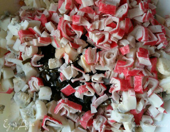 Берем пачку крабовых палочек либо крабового мяса (что есть под рукой), чистим от пленки, нарезаем также кубиками и отправляем в салатник. Можно добавить маленькую головку репчатого лука (кому нравится), но мы этого не делаем. Зелень я в салат не добавляю, считаю, что теряется вкус морской капусты.