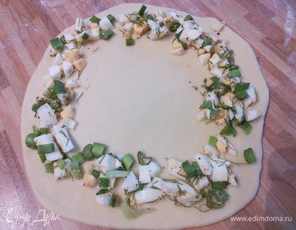 Раскатать тесто круглой формы, выложить по краям начинку.