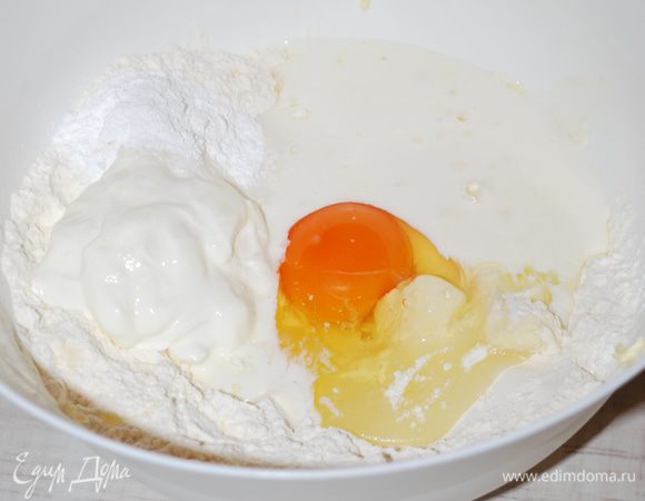 Делаем тесто. В муку добавляем 150 г масла, руками растираем масло с мукой. Убираем 2 столовые ложки сухой смести для посыпки пирога. Добавляем в мучную смесь 1 яйцо, 100 г сметаны,150 г кефира, соль и 3 столовые ложки сахара. Замешиваем тесто.