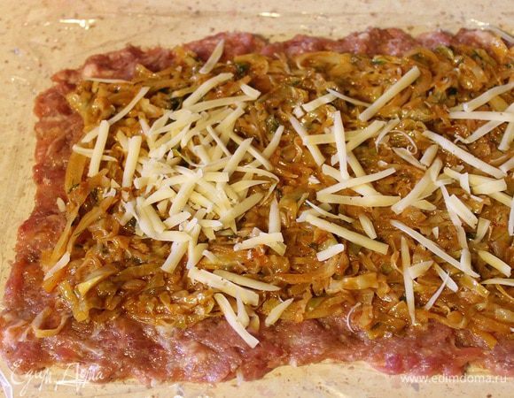 Сверху выложить начинку из капусты и посыпать сыром, натертым на крупной терке.